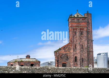 Historic Grade II listed abandoned hydraulic accumulator tower Engine House at Bramley Moore Dock, with modern buildings at Wellington Dock, Regent Ro Stock Photo
