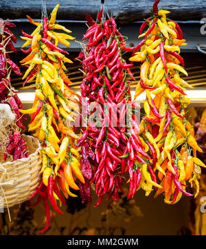 Peppers hanging on fruit & veg stall Stock Photo - Alamy