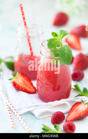 Healthy antioxidant red smoothie with apple juice, fresh strawberries, raspberries and mint Stock Photo