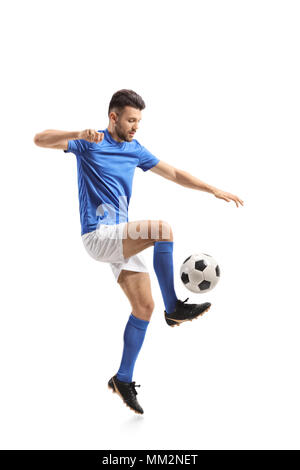 Full length profile shot of a soccer player juggling isolated on white background Stock Photo