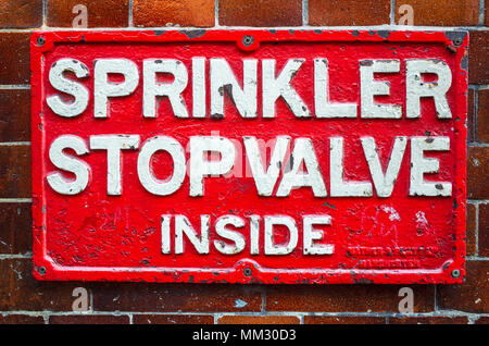 Colourful street signs - Sprinkler Stop Valve Inside - London UK Stock Photo