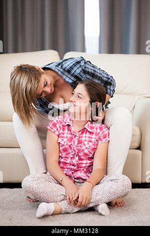 Mother is combing her daughter hair Stock Photo