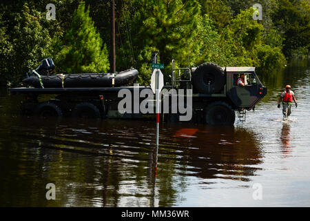 A unit with the 551st Multi-Role Bridge Company out of El Campo, Texas searches for flooded neighborhoods in Orange, Texas to patrol with their boats, Sept. 3, 2017. Hurricane Harvey formed in the Gulf of Mexico and made landfall in southeastern Texas, bringing record flooding and destruction to the region. (U.S. Air Force photo by Master Sgt. Joshua L. DeMotts) Stock Photo