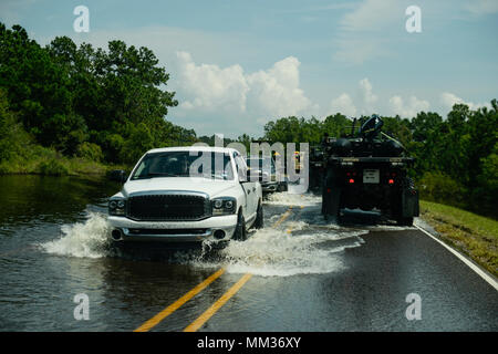 A unit with the 551st Multi-Role Bridge Company out of El Campo, Texas searches for flooded neighborhoods in Orange, Texas to patrol with their boats, Sept. 3, 2017. Hurricane Harvey formed in the Gulf of Mexico and made landfall in southeastern Texas, bringing record flooding and destruction to the region. (U.S. Air Force photo by Master Sgt. Joshua L. DeMotts) Stock Photo