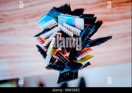 Professional hairdresser tools on table. Toned image. Many brushes for dyeing hair in a glass Stock Photo