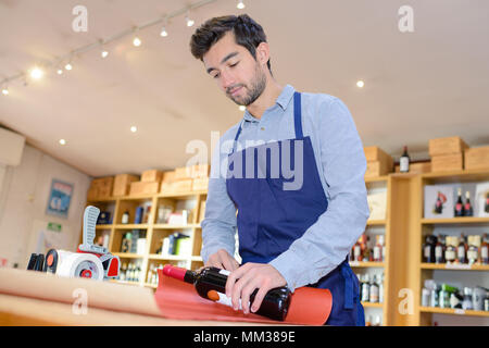 sommelier wrapping a bottle of wine Stock Photo