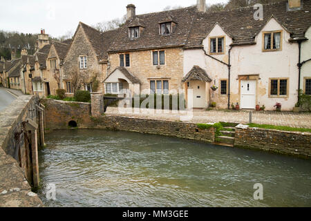 water lane wool workers cottages and bridge over the by brook with steps down to the water Castle Combe village wiltshire england uk Stock Photo