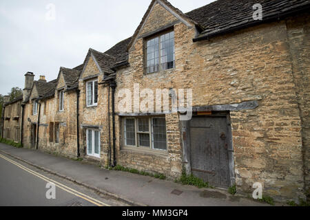 old historic stone built and stone tiled roof cottages on the street including corbett cottage in Castle Combe village wiltshire england uk Stock Photo