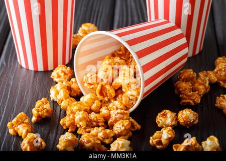 Delicious caramel popcorn in paper cups close-up on the table. horizontal Stock Photo