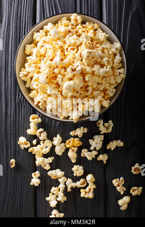popcorn cheese in a bowl closeup on a table. Vertical top view from above Stock Photo