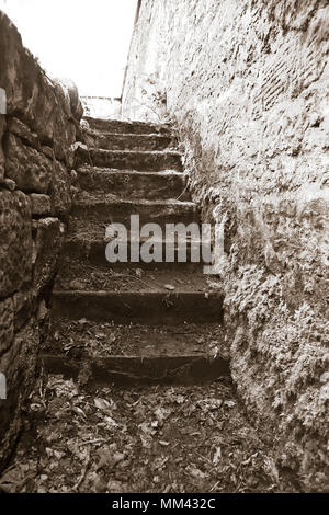 Rough hewn ancient stone steps, worn with time Stock Photo