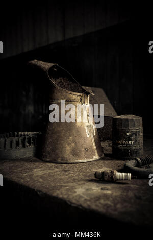 old rusty oil cans in garage Stock Photo
