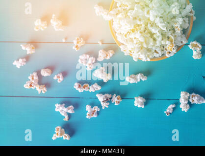 Popcorn texture. Popcorn snacks as background. on blue wood background Stock Photo