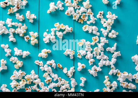 Popcorn texture. Popcorn snacks as background. on blue wood background Stock Photo