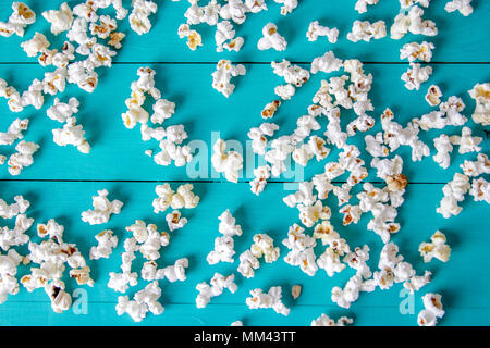 Popcorn texture. Popcorn snacks as background. on blue wood background Stock Photo