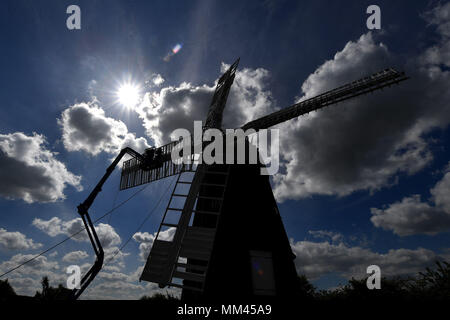 A new sail is fitted to Wicken Village windmill in Cambridgeshire. Stock Photo