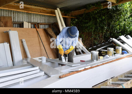 Shutters are painted before being fitted to the new sail of Wicken Village windmill in Cambridgeshire. Stock Photo