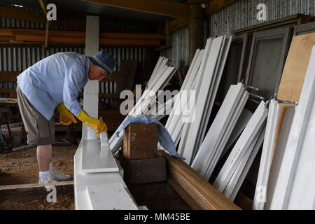 Shutters are painted before being fitted to the new sail of Wicken Village windmill in Cambridgeshire. Stock Photo