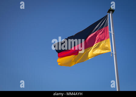 German flag waving against the blue sky Stock Photo