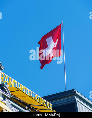 Montreux, Switzerland - October 18, 2017: The Swiss flag waving on the building of Montreux Palace Stock Photo