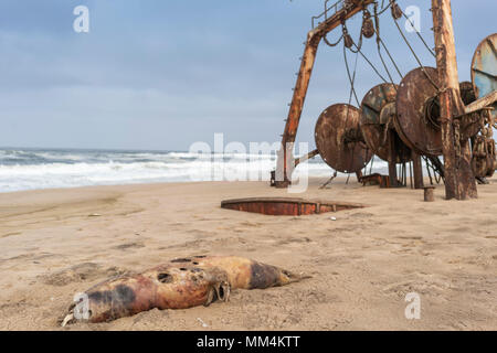 Ship wrecked and buried and abandoned on the coast of the Namibe Desert. Africa, Angola. Stock Photo