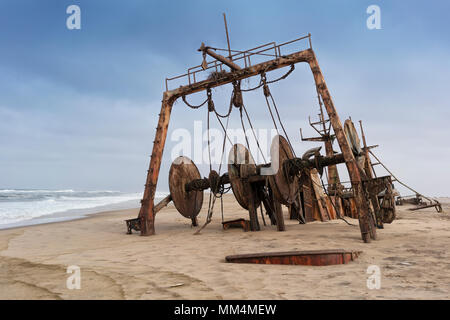 Ship wrecked and buried and abandoned on the coast of the Namibe Desert. Africa, Angola. Stock Photo