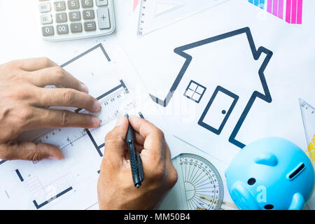 Business, architecture, building, construction concept - close up of architect working on blueprint . Stock Photo