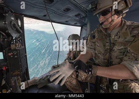 Staff Sgt. Justin Bender, 374th Operations Support Squadron survival, evasion, resistance and escape specialist, wears gloves over Sagami Bay, Japan, Sept. 1, 2017, during the 2017 Big Rescue Kanagawa Disaster Prevention Drill. Airmen of the 459 AS demonstrated their rescue capabilities among local participants during the Big Rescue Kanagawa for the first time. (U.S. Air Force photo by Yasuo Osakabe) Stock Photo