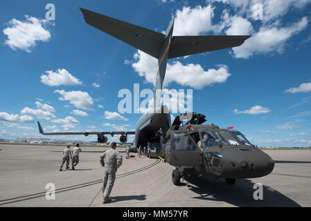 Two UH-60 Blackhawk helicopters from the Kentucky Army National Guard’s 63rd Theater Aviation Brigade are loaded into a U.S. Air Force C-17 Globemaster III aircraft at the Kentucky Air National Guard Base in Louisville, Ky., Sept. 7, 2017 to assist with Hurricane Irma relief efforts. The two army aircraft are equipped with medical evacuation equipment necessary to accomplish search and rescue operations. (U.S. Air Force photo by Staff Sgt. Joshua Horton) Stock Photo