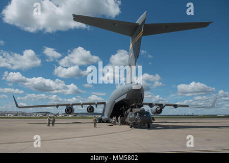 Two UH-60 Blackhawk helicopters from the Kentucky Army National Guard’s 63rd Theater Aviation Brigade are loaded into a U.S. Air Force C-17 Globemaster III aircraft at the Kentucky Air National Guard Base in Louisville, Ky., Sept. 7, 2017 to assist with Hurricane Irma relief efforts. The two army aircraft are equipped with medical evacuation equipment necessary to accomplish search and rescue operations. (U.S. Air Force photo by Staff Sgt. Joshua Horton) Stock Photo