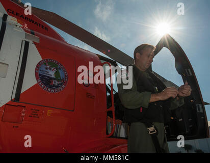 Cmdr. Matthew Furlong, MH-60 Jayhawk helicopter pilot at Coast Guard Air Station Clearwater, prepares to evacuate Friday, Sept. 8, 2017 in preparation for Hurricane Irma. The Coast Guard reminds all mariners that rescue and assistance may be severely degraded or unavailable immediately before, during and after a devastating storm. (U.S. Coast Guard photo by Petty Officer 1st Class Michael De Nyse) Stock Photo
