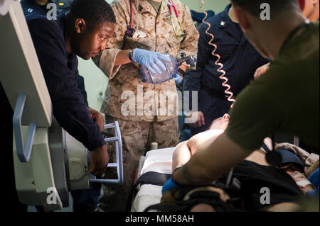 Alligator Dagger 2017 was a unilateral combat rehearsal exercise led by Naval Amphibious Force, Task Force 51/5th Marine Expeditionary Brigade within the U.S. 5th Fleet area of operations. The archival image documents a casualty evacuation drill conducted on September 8, 2017, involving Navy medical personnel supporting integrated Navy and Marine Corps units embarked with an amphibious ready group. The historical photographic print records medical readiness training at sea. Stock Photo
