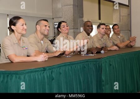 A panel of U.S. Marine Corps officers, assigned to the Special Purpose Marine Air Ground Task Force Detroit, give applause to attendees at the Marine Corps Leadership Seminar at Wayne State University, during Marine Week Detroit, Sept. 8, 2017. Marine visit colleges and universities to hold Marine Corps Leadership Seminar as part of Marine Week Detroit in the greater Detroit, Mich. Area, Sept. 6-8, 2017. (U.S. Marine Corps photo by Lance Cpl. Cristian L. Ricardo) Stock Photo