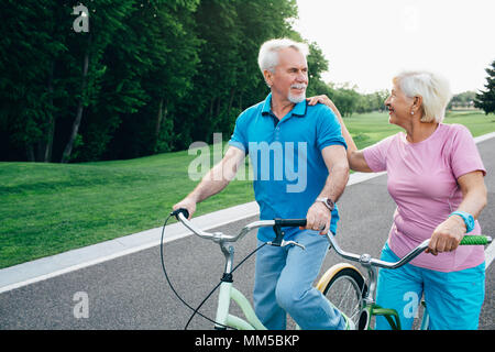 Happy senior couple riding bicycles Stock Photo