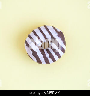 Tasty donut isolated on yellow pastel background minimal creative concept. Stock Photo