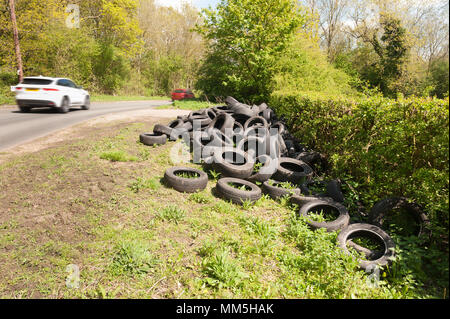 Disgraceful fly tipping of many car tyres alongside a country lane in kent just off a main road, Old Terry's Lodge Road, Kemsing Stock Photo