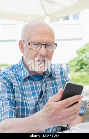Senior man using smart phone Stock Photo