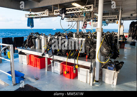 Scuba diving gear on the deck of a live aboard boat ready for the next dive on The Great Barrier Reef Australia. Stock Photo