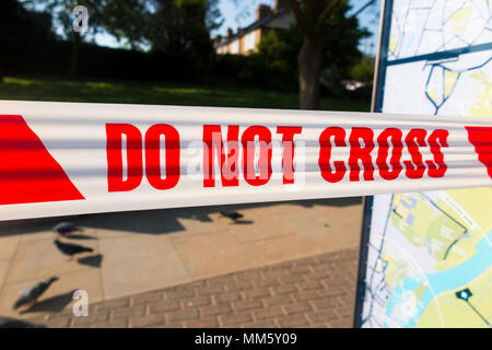 Inner cordon tape barrier placed by police or scene of crime officer / officers at the site of a stabbing where someone was stabbed with a knife. UK Stock Photo