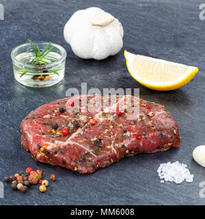 Meat raw beef steak square on slate top view Stock Photo