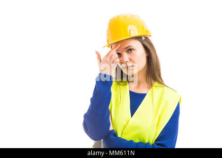 Young attractive female architect or engineer thinking and touching forehead as pensive specialist concept isolated on white background Stock Photo