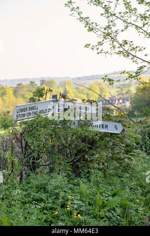 Upper and Lower Slaughter signpost in spring. Cotswolds, Gloucestershire, England Stock Photo