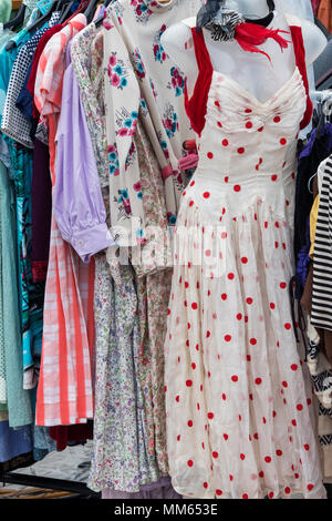 Old vintage womens clothing  for sale on a rack at a retro vintage car boot sale. Granary Square, Kings Cross, London Stock Photo