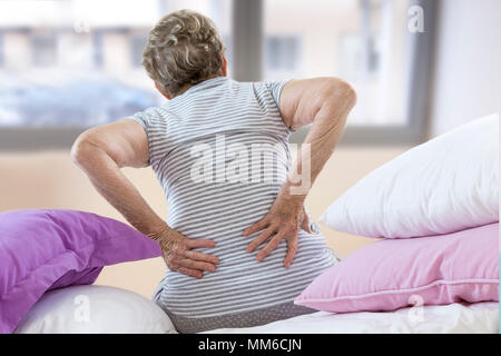 SENIOR WITH LOWER BACK PAIN Stock Photo