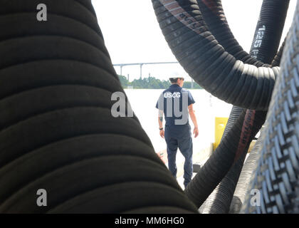 Marine Safety Unit Savannah is a United States Coast Guard command tasked with maritime safety and environmental enforcement in Savannah, Georgia. The archival image records a marine science technician conducting a post Hurricane Irma inspection of transfer equipment and shoreline facilities at Colonial Terminals Inc. on September 12, 2017, focusing on storm related damage and pollution control. Stock Photo