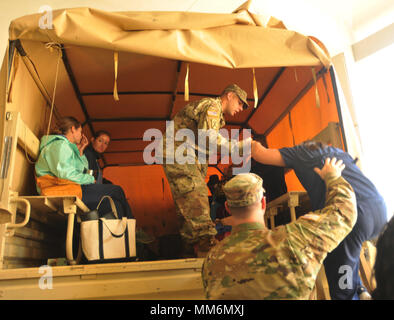 U.S. Soldiers assigned to Headquarters and Headquarters Company, 218th  Maneuver Enhancement Brigade, South Carolina Army National Guard complete a  high-water rescue mission by transporting nurses in the back of a Light  Medium