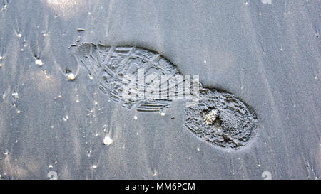 PULAU LANGKAWI, MALAYSIA - APR 7th 2015: Famous black sand beach with footprint. Stock Photo