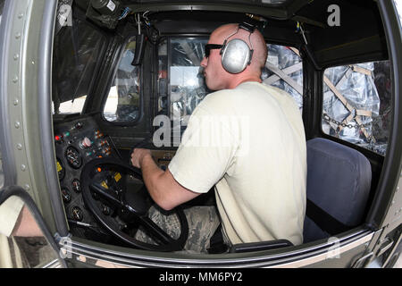 An airmen from the 72nd Logistics Readiness Squadron, aerial port section, controls the movement of palletized cargo on to a C-17A Globemaster III from the 445th Airlift Wing, Wright-Patterson Air Force Base, Ohio, Air Force Reserve Command, as members of the 35th Combat Communciations Squadron and their equipment deploy Sept. 13, 2017, from Tinker Air Force Base, Oklahoma, to Florida. The deployment is part of the Air Force's Hurricane Irma response and recovery operations to provide humanitarian relief. The eight Citizen Airmen from the 35th CBCS deployed servers, radio equipment, power gene Stock Photo