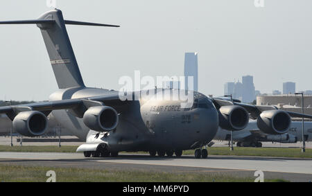 A C-17A Globemaster III from the 445th Airlift Wing, Wright-Patterson Air Force Base, Ohio, Air Force Reserve Command, moves in front of the iconic skyline of downtown Oklahoma City, Oklahoma after loading equipment and members of the 35th Combat Communciations Squadron Sept. 13, 2017, Tinker Air Force Base, Oklahoma. The 35th CBCS is deploying  to Florida as part of the Air Force's Hurricane Irma response and recovery operations to provide humanitarian relief. The eight Citizen Airmen from the 35th CBCS deployed servers, radio equipment, power generation and other tools to connect to Departme Stock Photo