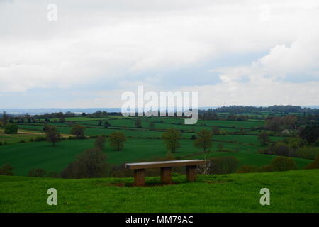 Picture of empty bench overlooking Staffordshire Countryside. Depicts loneliness and depression on a dull drizzly day in the countryside. Stock Photo